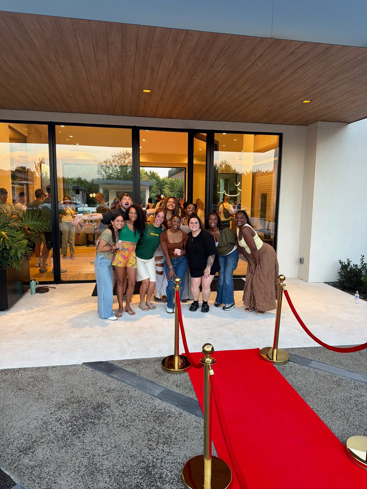 Friends gathered on the red carpet at a Sunday S'mores house party