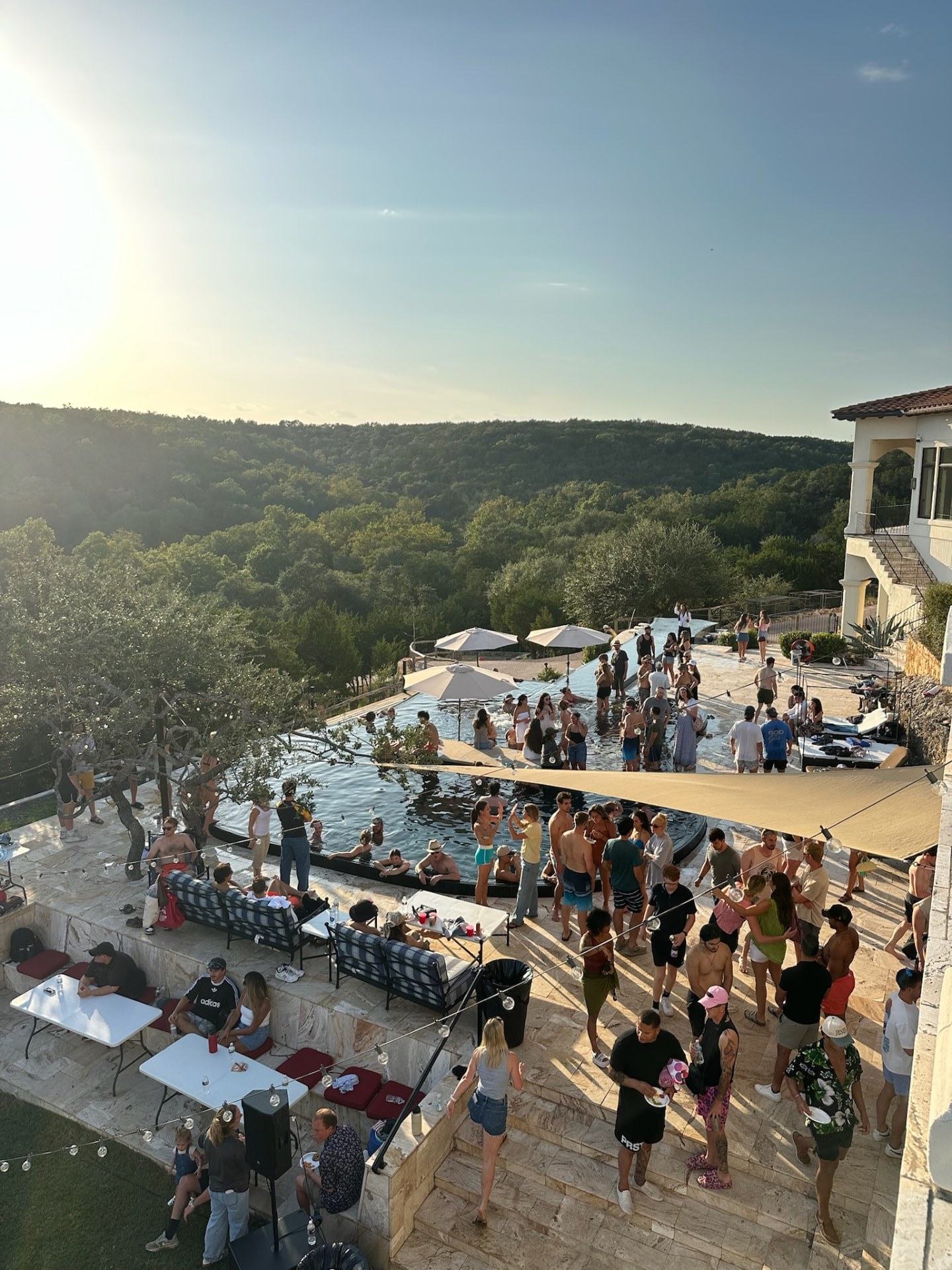 Sunday S'mores guests connecting on a sunny poolside patio